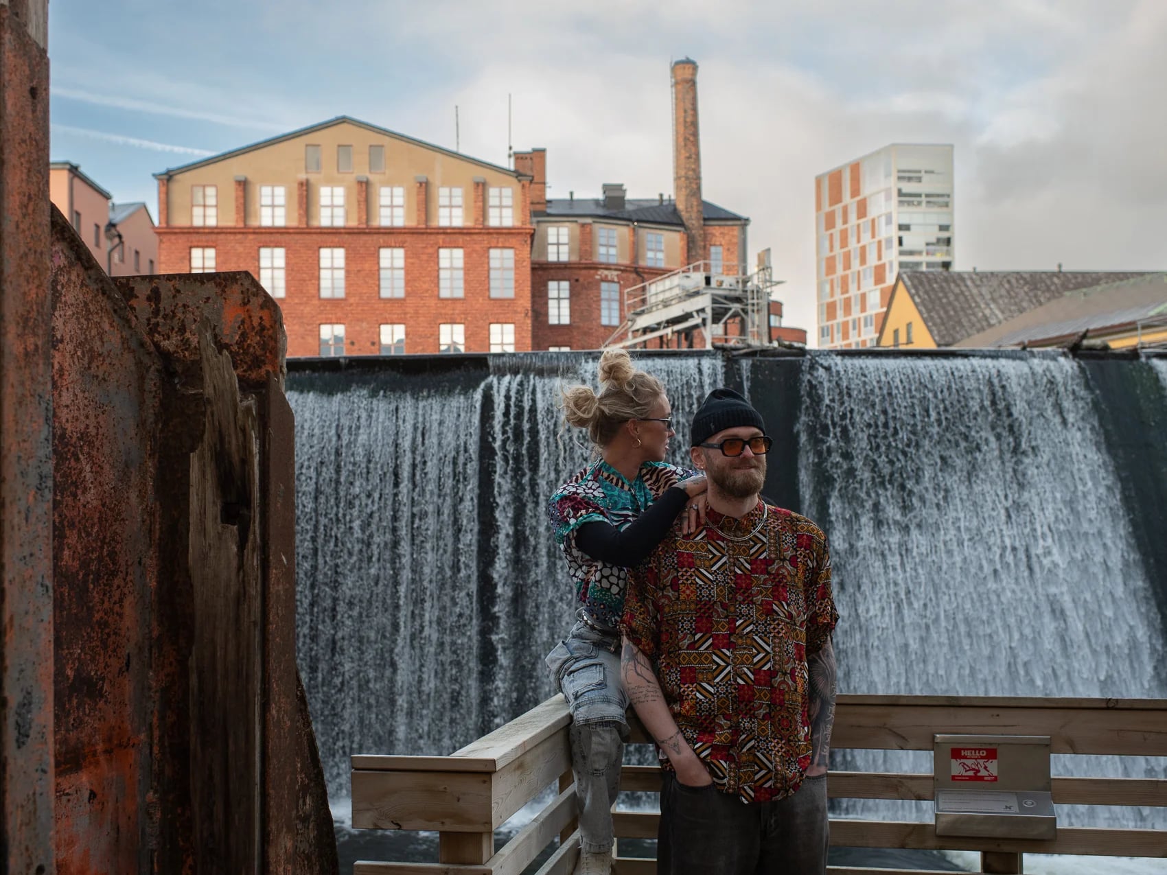 Couple in 2CC prints by the waterfall at the Norrköping mills